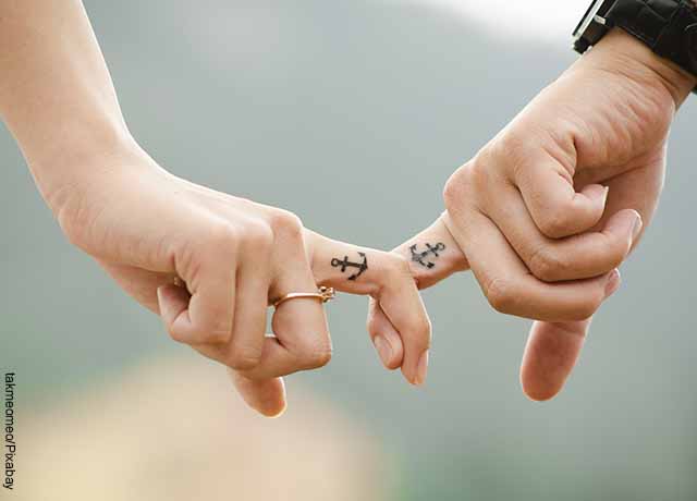 Foto de una pareja tomándose los dedos
